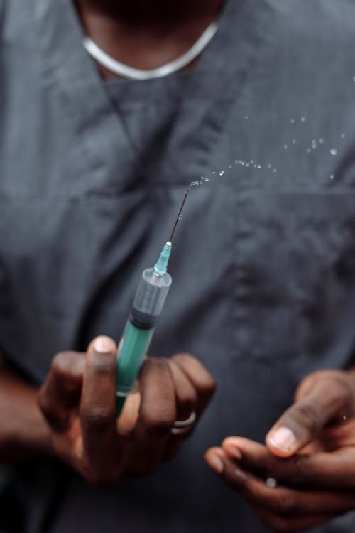 A Medic Holding a Syringe