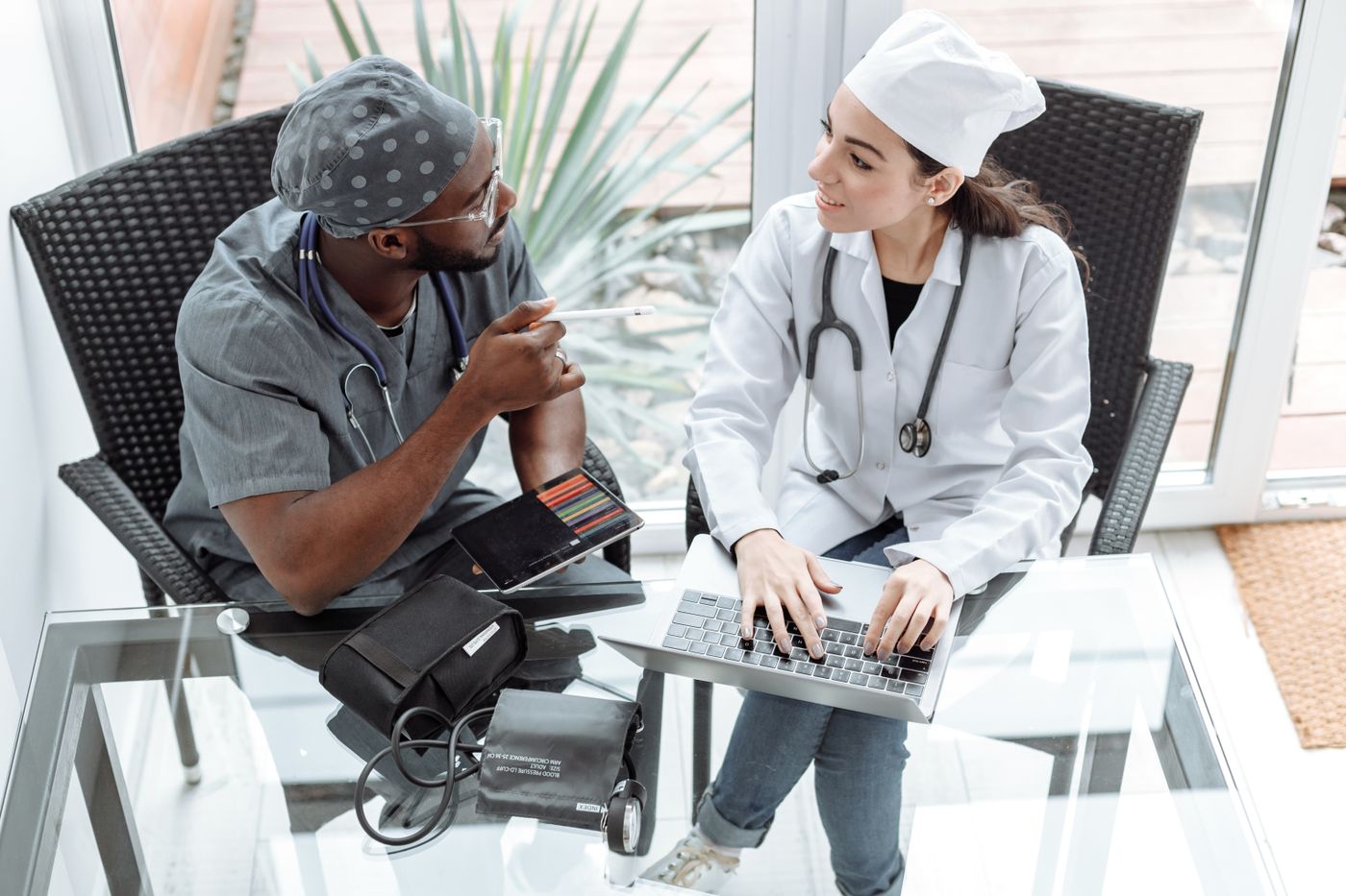 Doctors reviewing healthcare information on a laptop and tablet