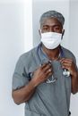 Man in Blue Scrub Suit With White Face Mask