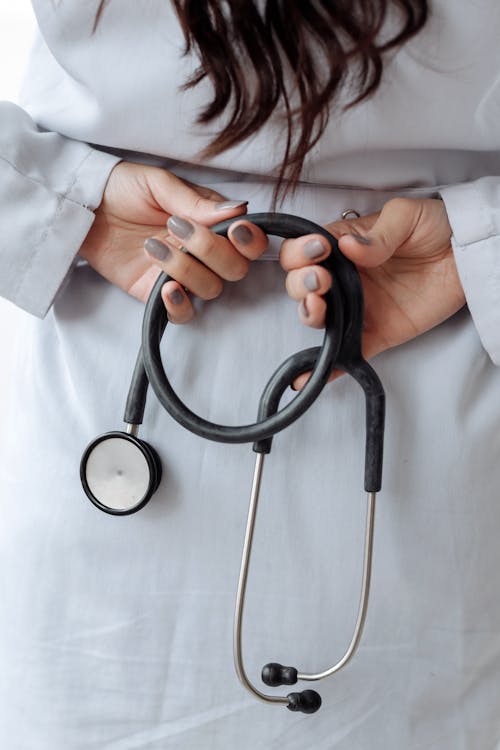 Free Hands with Gray Nail Polish on Her Fingers while Holding Stethoscope Stock Photo