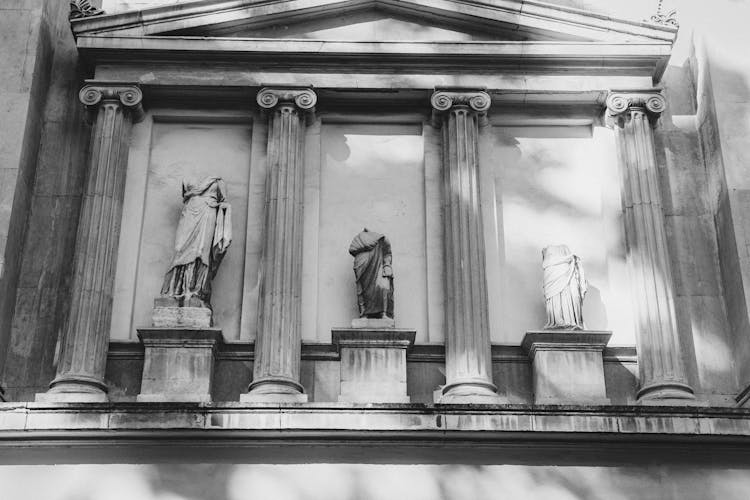 Grayscale Photo Of Headless Statues