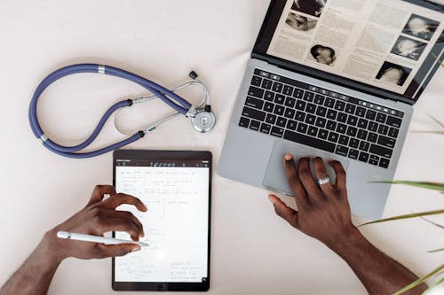 A Medical Person Using a Laptop for Research