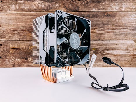 Detailed close-up of a CPU cooling fan and heatsink on wooden background, highlighting modern technology.
