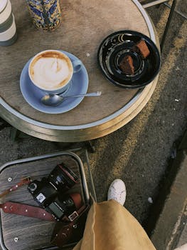 Top-down view of a cappuccino and brownies on a cafe table in Oxfordshire.