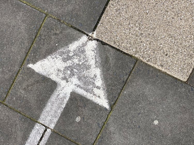 An Arrow Sign On The Ground