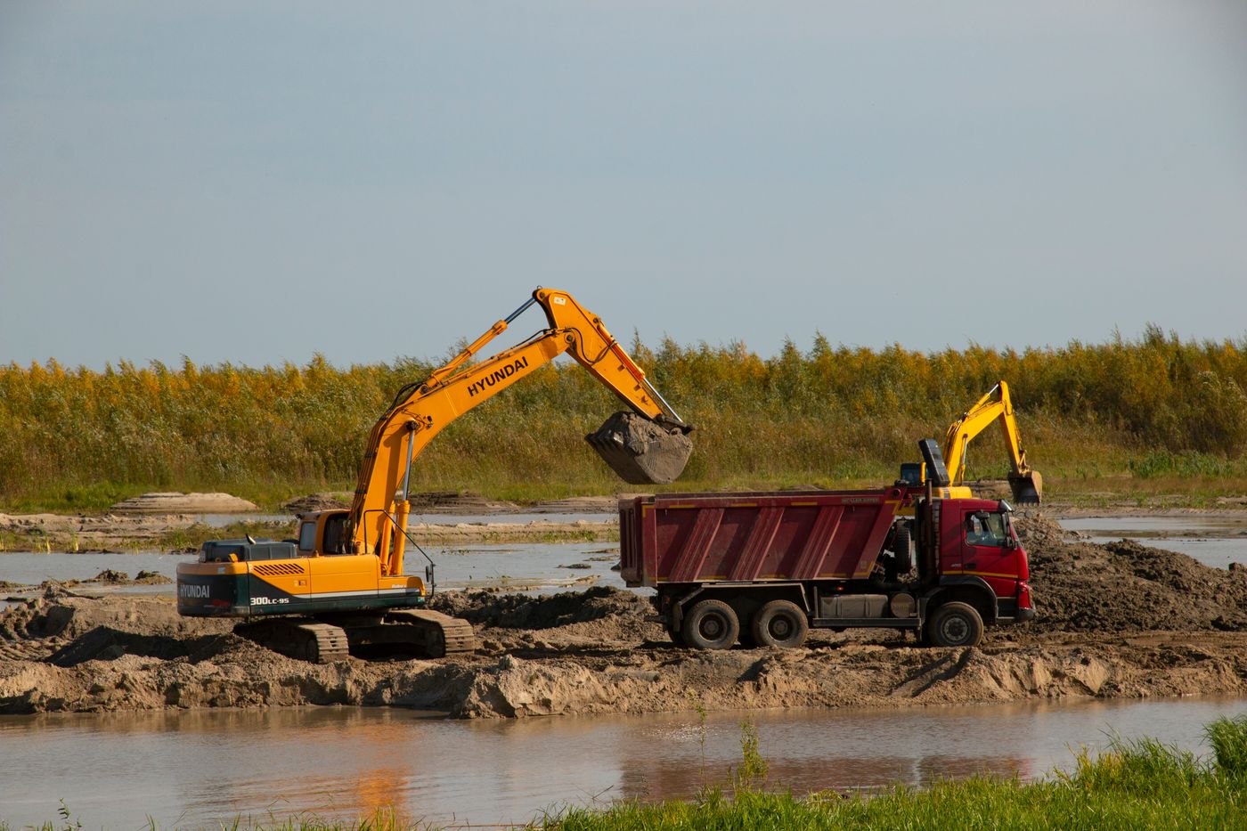 Heavy construction equipment moving material at a work site