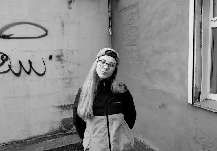 Girl In Baseball Cap And Sportswear On Street