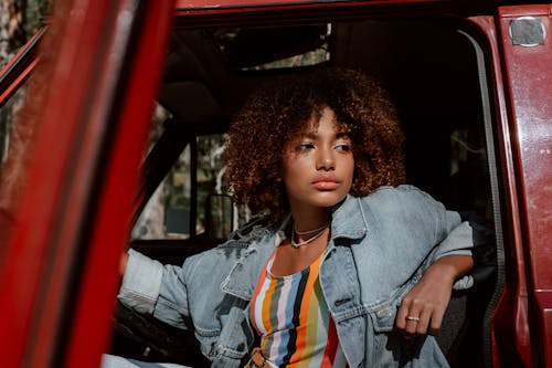 A Woman in Blue Denim Jacket Sitting Inside the Car