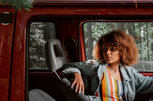 Woman with Curly Hair Inside the Vehicle