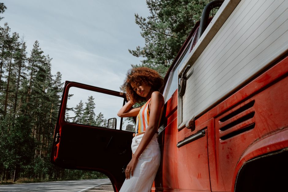 woman standing next to car driveway