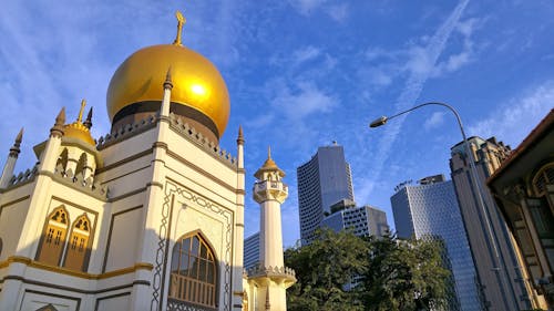 White and Gold Mosque Near High-rise Buildings