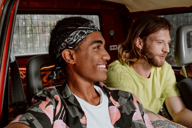 Happy Men Sitting Inside A Vehicle