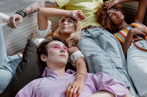 Woman in Purple Shirt Lying on Man in Black Shirt