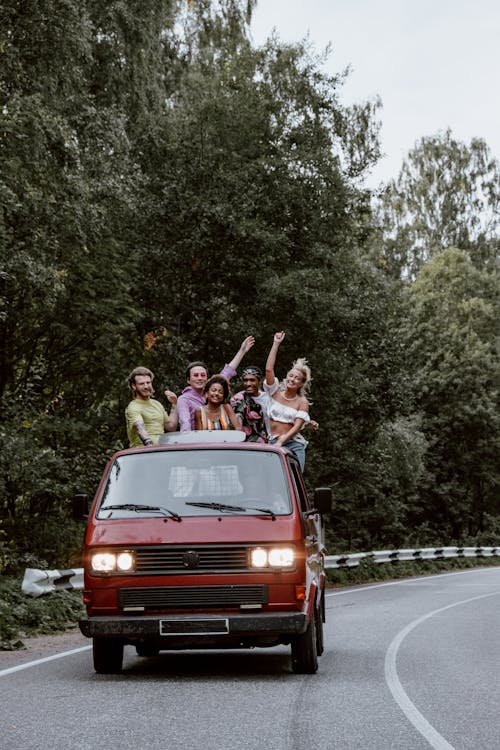 Friends Having Fun while Riding at the Back of a Pickup Truck