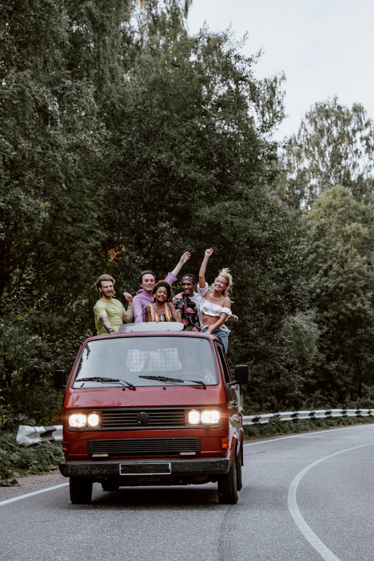 Friends Having Fun While Riding At The Back Of A Pickup Truck