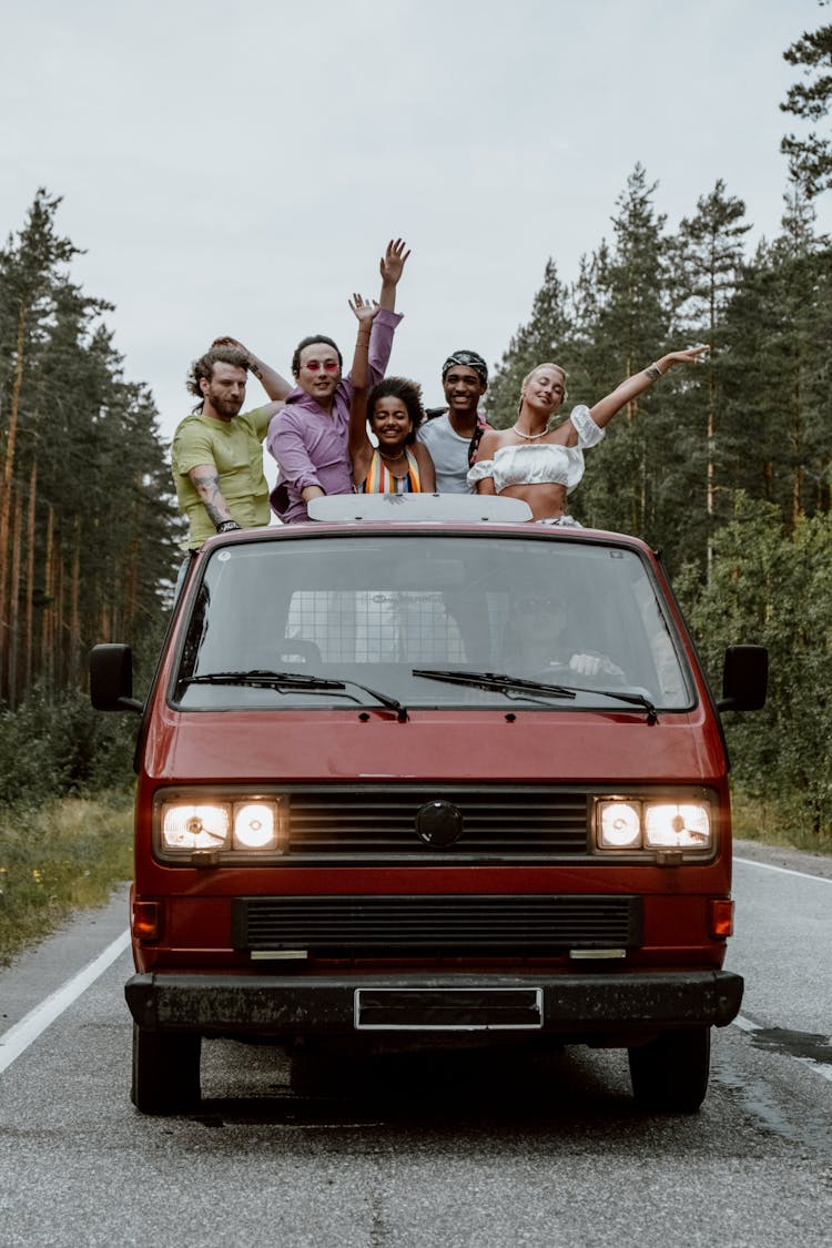 Friends Having Fun While Riding At The Back Of A Pickup Truck