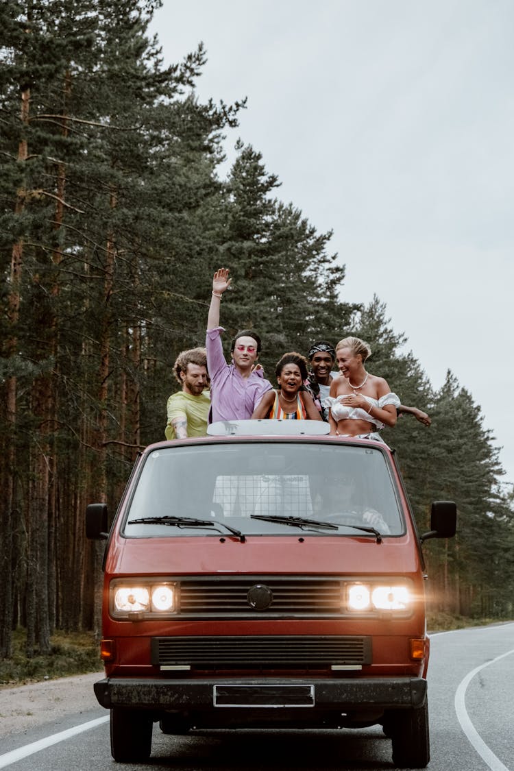 Friends Having Fun While Riding At The Back Of A Pickup Truck