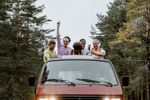 Friends Having Fun while Riding at the Back of a Pickup Truck