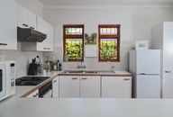 A Clean Kitchen with Cupboards and Kitchenware