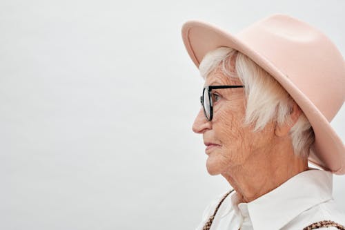 Free An Elderly Woman Wearing a Hat Stock Photo