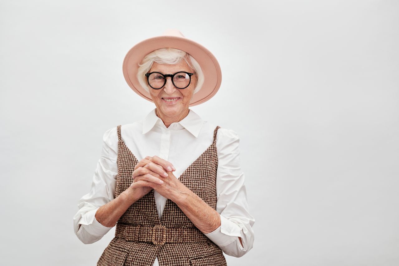 fashionable senior woman smiling confidently in a stylish outfit with