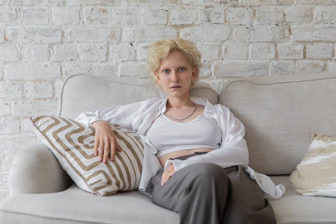 Charismatic woman relaxing on sofa at home
