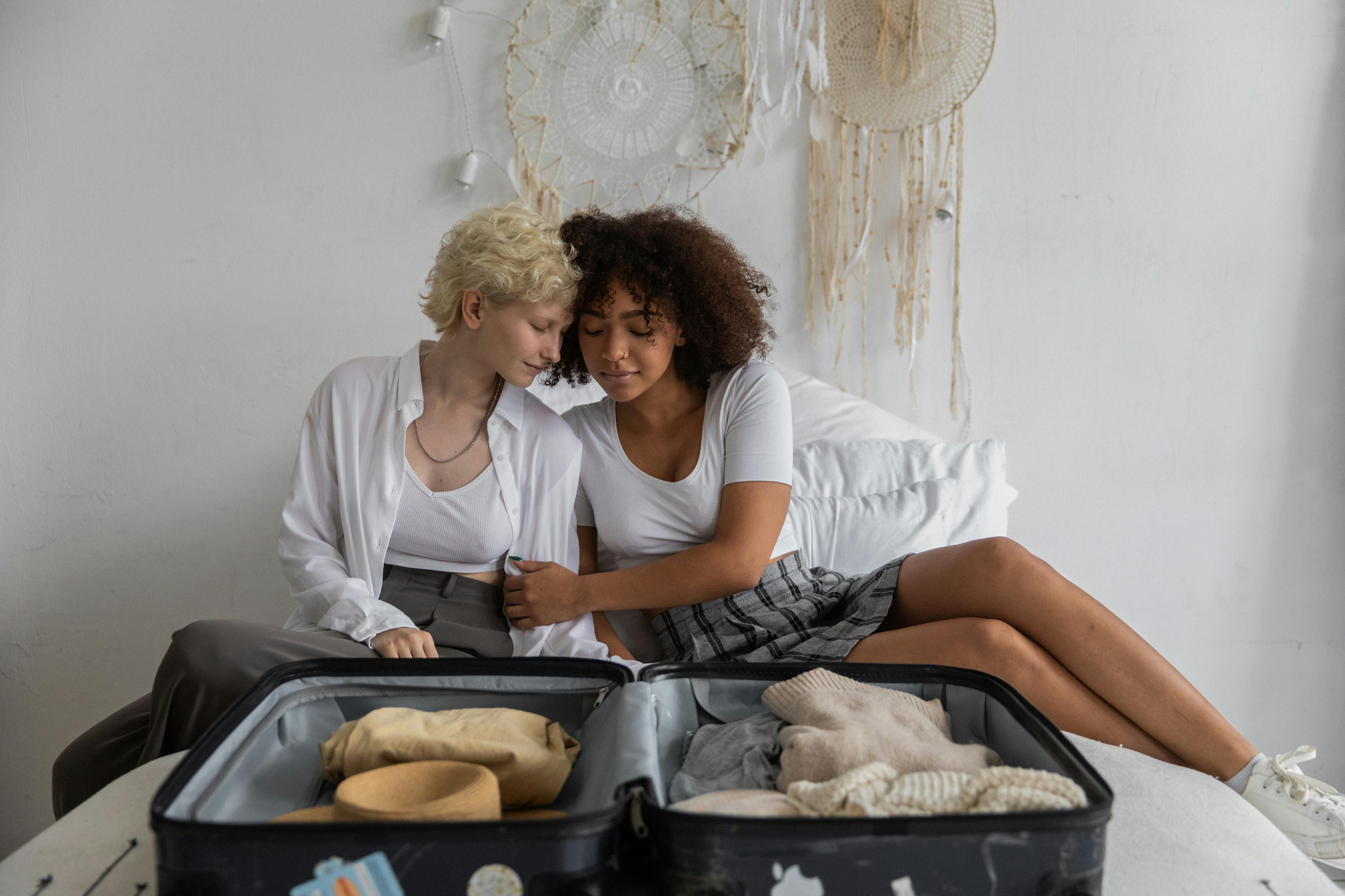 diverse lesbian couple caressing on bed