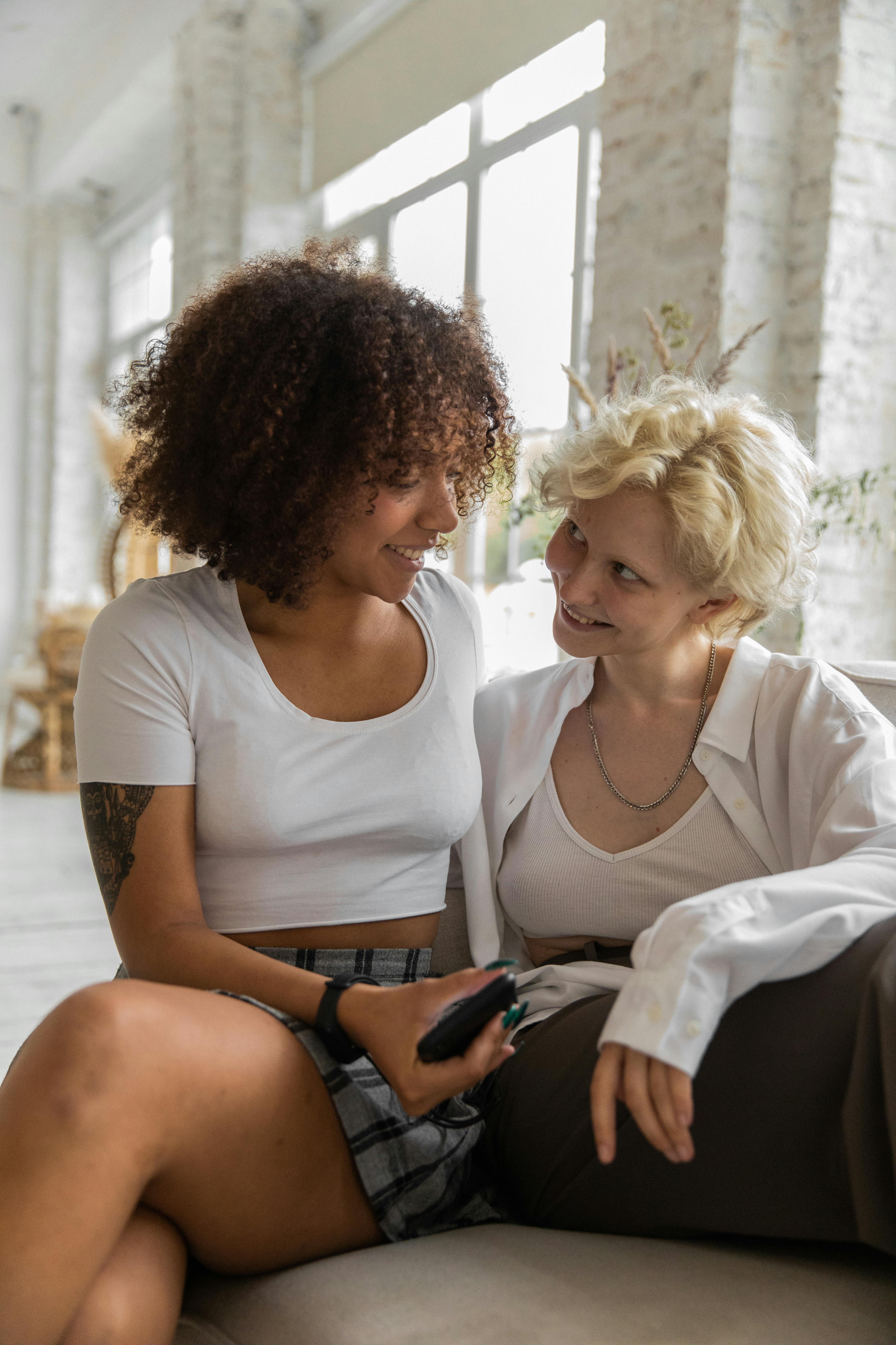 happy multiethnic couple hugging while relaxing at home