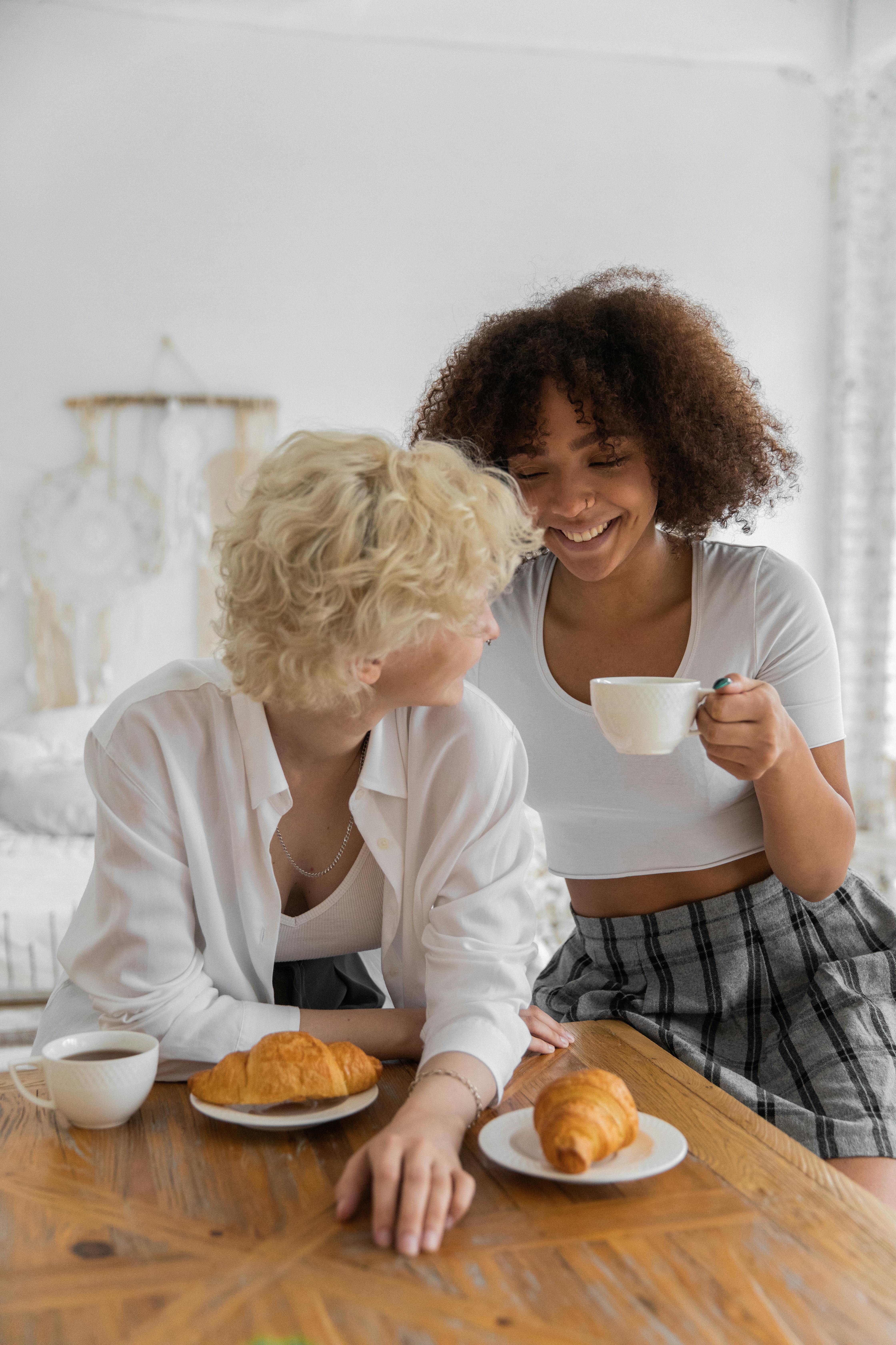 happy diverse girlfriends having coffee break