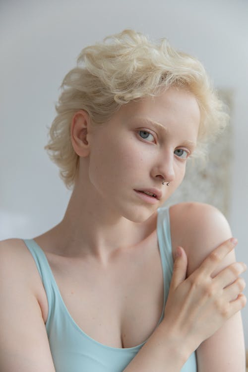 Free Pensive young blonde looking at camera in daylight Stock Photo