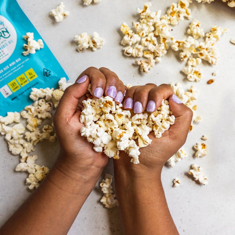 Person's Hands With Popcorns