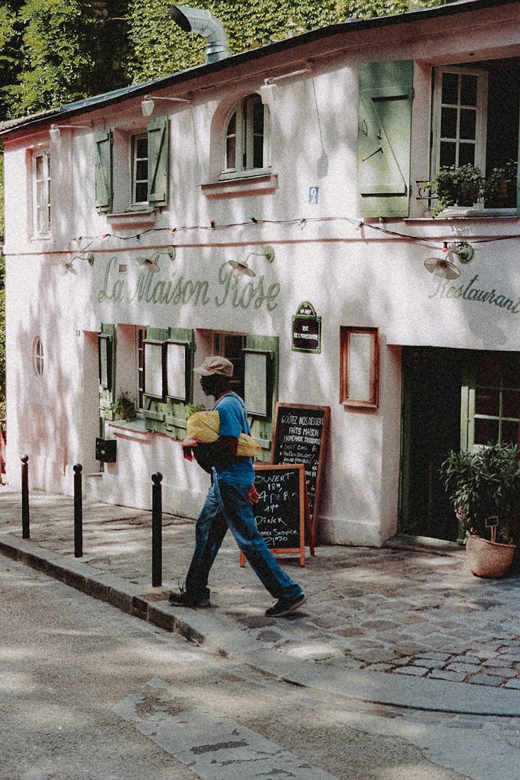 Unrecognizable Black Man Walking On Street