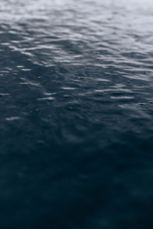 Free From above of dark glowing sea with ripples on water flow in twilight Stock Photo