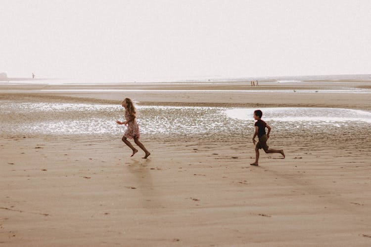 Kids Running On Sandy Beach