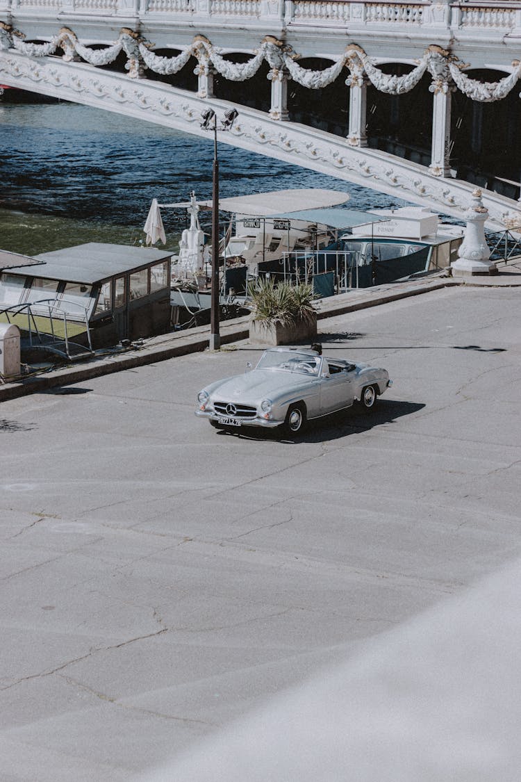 Old Shiny Convertible Driving On Vintage Bridge