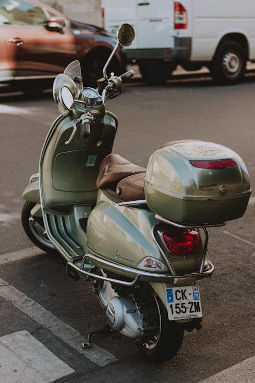 Free Vintage scooter on street with traffic Stock Photo