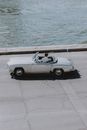Man in elegant outfit turning around on cabriolet