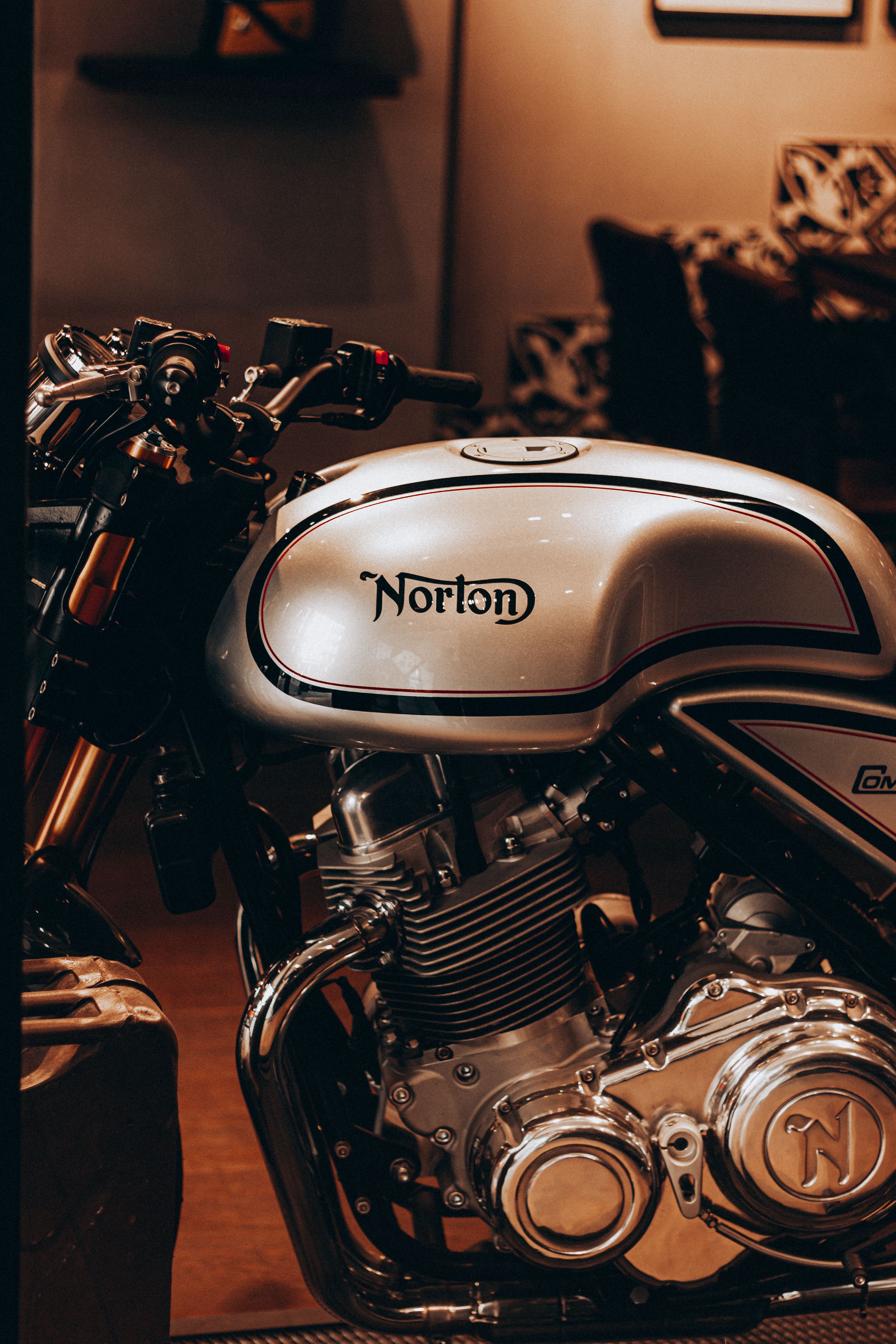 Heavy metal engine of contemporary motorcycle on blurred background of comfortable light restaurant