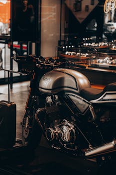 Fancy black motorcycle with silver bumper and pipes in local modern cafe