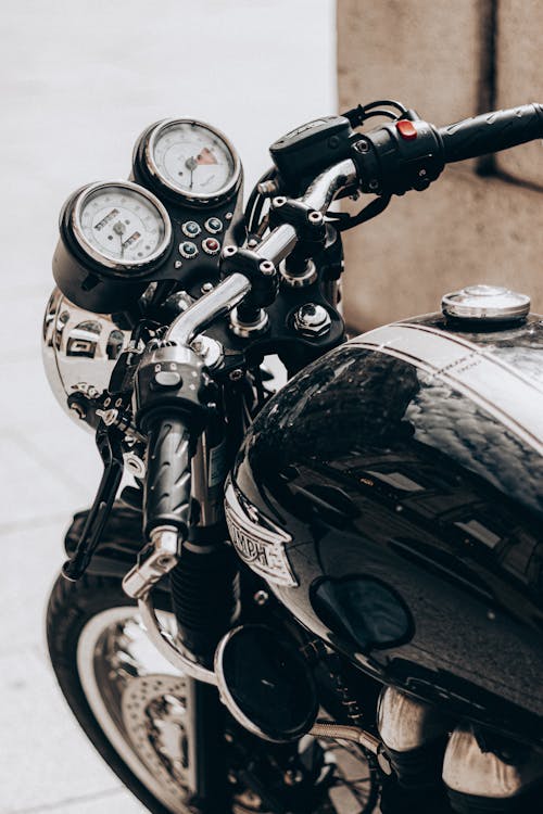Black gleaming motorcycle with speedometer on rudder