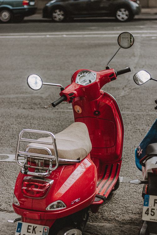 Free Vintage scooter placed on busy concrete street on local street of big city Stock Photo