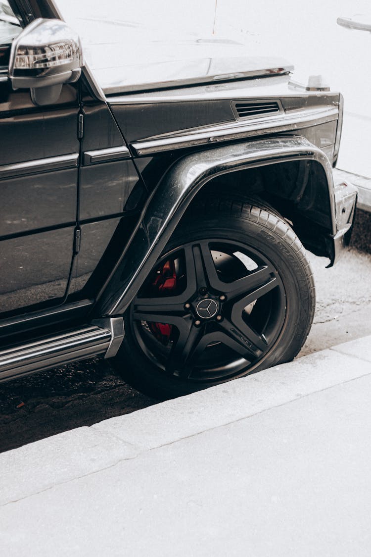 Wheel Of Prestigious Car Parked Near Curb