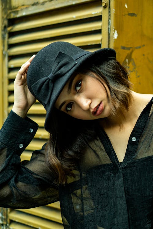 A Woman in Black Long Sleeve Shirt and Black Hat