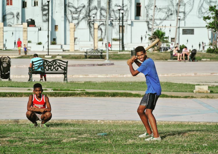 Teenagers Playing Baseball On The Park