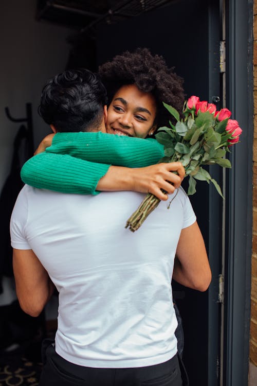 Free Man Giving Flowers to a Woman Stock Photo