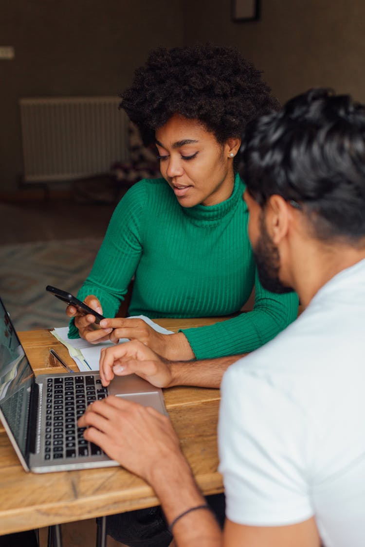 A Man And Woman Talking While Working Together