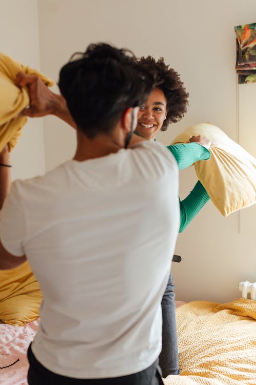 Man and Woman Holding Pillows