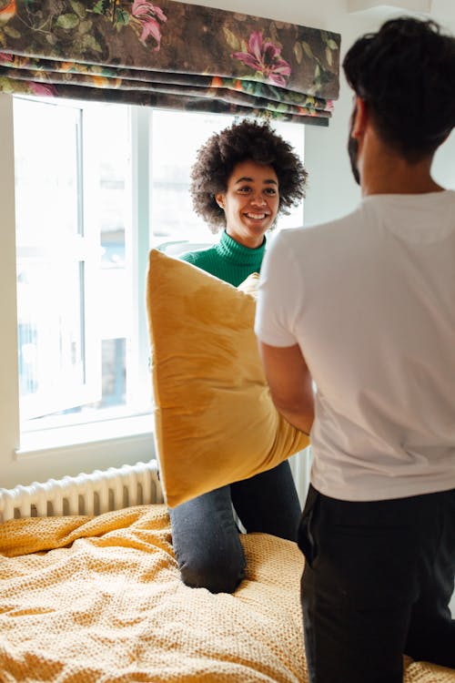 Woman Holding a Yellow Pillow