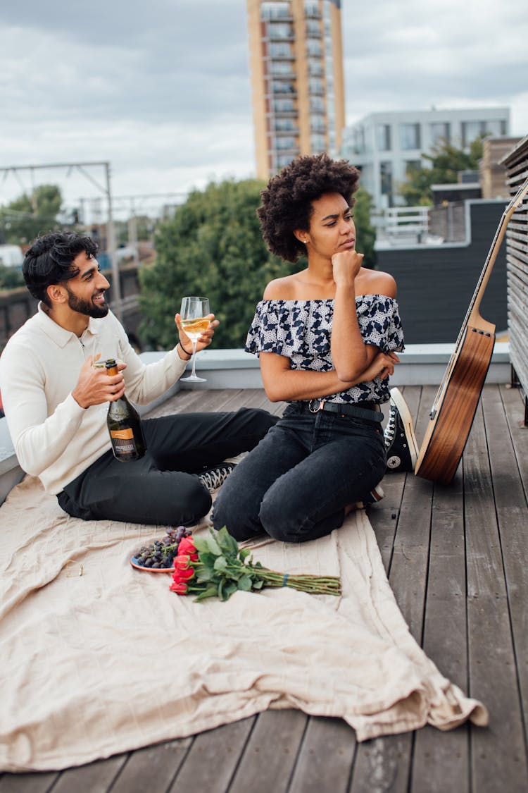 
A Couple Having A Picnic On A Rooftop