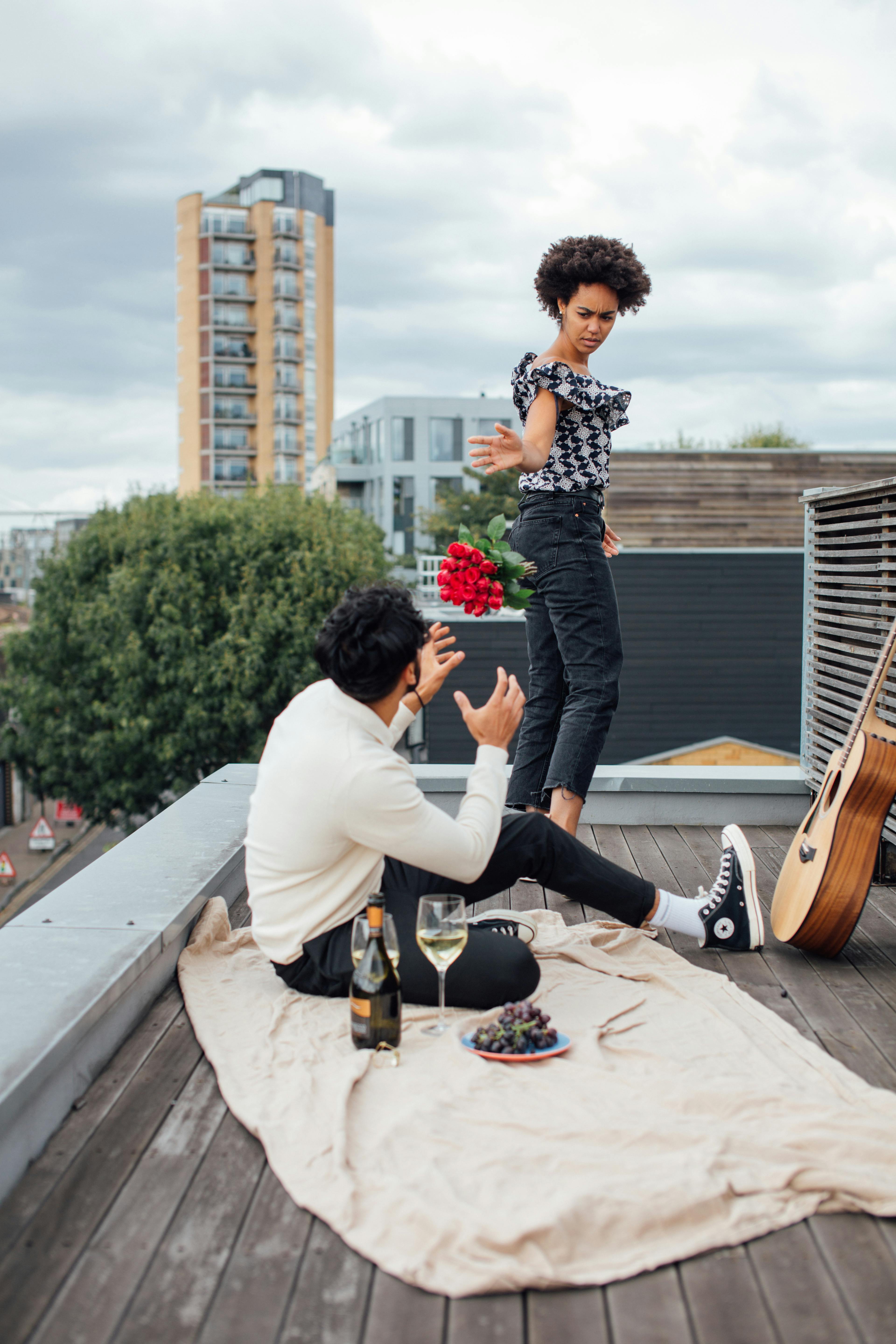 woman leaving a man sitting on rooftop